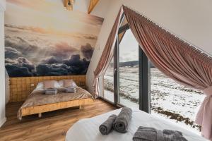 a bedroom with two beds and a large window at LakeHome&Spa nad Jeziorem Czorsztyńskim in Kluszkowce