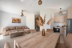 a kitchen and living room with a table and a couch at Ariadne Stay Complex by Horizon Homes in Ofrínion +45 photos