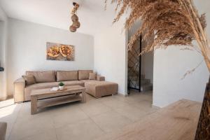 a living room with a couch and a table at Ariadne Stay Complex by Horizon Homes in Ofrínion