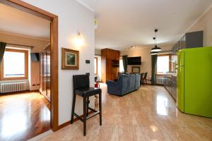 a living room with a green refrigerator and a chair at Central Square in Sirmione