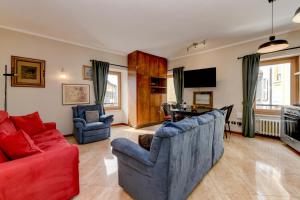 a living room with two chairs and a red couch at Central Square in Sirmione