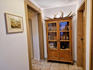 a room with a wooden cabinet with antlers on it at Haus am Thiesenring in Bad Berneck im Fichtelgebirge