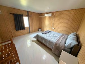 a bedroom with a bed and a television in it at NgopaKohKoodResort in Ban Bang Bao