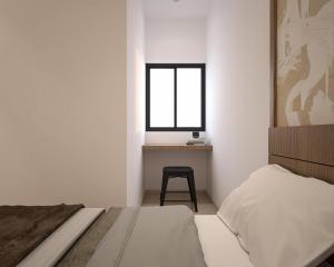 a bedroom with a bed and a desk with a window at Backwoods inn in Heggadadevankote