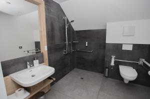a bathroom with a sink and a shower and a toilet at K1 Hotel Willingen in Willingen +28 photos