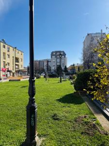 a black pole in the grass in a park at Zulu Apartments and Studios in Kumanovo