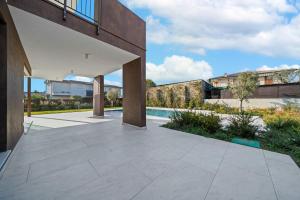 an open patio with a pool and a building at NNV Pool Villa Lazise in Lazise
