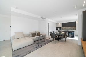 a living room with a white couch and a table at NNV Pool Villa Lazise in Lazise