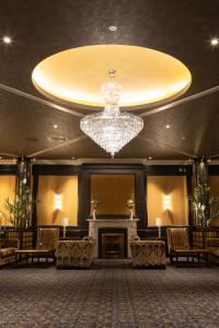 a large lobby with a chandelier and a fireplace at The Grand Hotel in Malahide