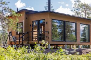 a house with glass doors and windows at WALD Villas - Aavasaksa, Lapland in Aavasaksa