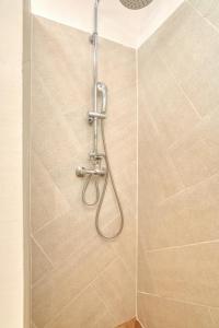 a shower with a shower head in a bathroom at Best view! Rooftop with Garden - Old Town Nr404 in Kotor