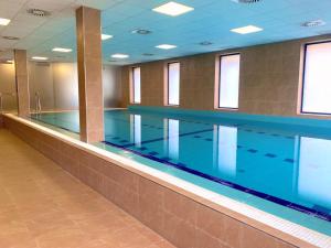 a large swimming pool in a large room at Hotel Panská Zahrada in Dobřichovice