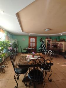 a dining room with a table and a christmas tree at Садиба У Коса in Pilipets