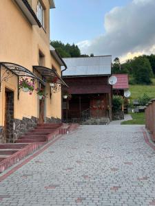 a building with steps and a building with a building at Садиба У Коса in Pilipets