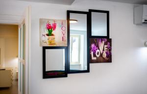 a group of mirrors on a wall with flowers at DeLuxe Afrodita Apartment in Rovinj