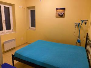 a bedroom with a blue bed in a room at Villa Effie in Aspro Chorio Paros +13 photos