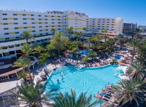 an aerial view of a resort pool with palm trees at Abora Continental by Lopesan Hotels in Playa del Ingles