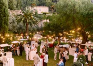 a group of people standing in a garden at a party at La Residencia, A Belmond Hotel, Mallorca in Deia +123 photos