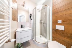 a bathroom with a shower and a toilet and a sink at S12 Boutique Residence - by Hosty in Krakow +179 photos