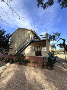 a house with a staircase leading up to it at Estudio "La Cochera de Sorrapa" in Deltebre