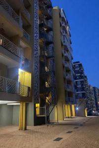 two tall apartment buildings at night with lights at Nuellas Haven in Kira