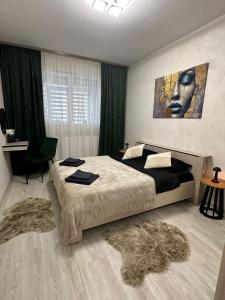 a bedroom with a large bed and a painting of a woman at DIAMOND MIRAGE Militari Residence in Chiajna