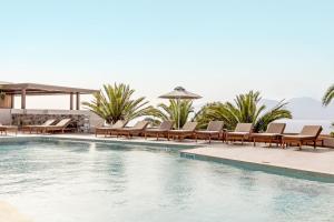 a pool with chaise lounge chairs and a swimming pool at Casa Elounda - Adults only Hotel "by Checkin" in Agios Nikolaos +22 photos