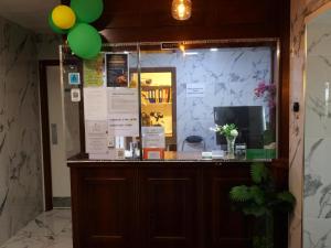 a shop with a window with green balloons at Stay Inn Express, Cambridge in Cambridge