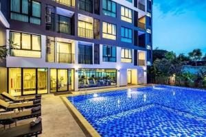 a large swimming pool in front of a building at Therizinpattaya in Pattaya South +10 photos