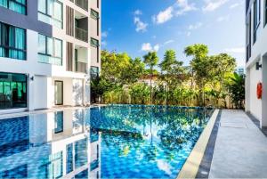 a swimming pool in the middle of a building at Therizinpattaya in Pattaya South