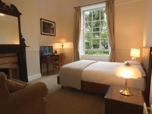 a hotel room with a bed and a window at Harveys Guest House in Dublin