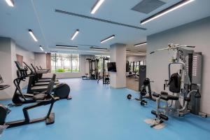 a gym with several treadmills and cardio machines at Yevlakh City Hotel in Yevlax