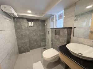 a bathroom with a toilet and a sink at Regenta Z Vadodara in Vadodara +17 photos