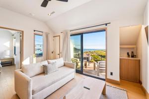 a living room with a couch and a view of the ocean at Offshore Spa & Residences in Montauk