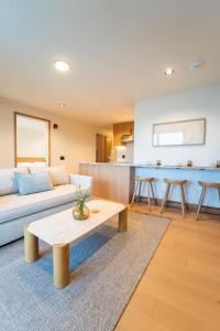 a living room with a couch and a table at Offshore Spa & Residences in Montauk