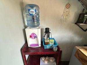 a bottle of water sitting on top of a table at Naca Homestay in Manado