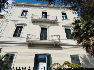 a white building with two balconies on it at Palazzo Castellano in Lecce