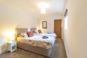 a bedroom with a large bed in a room at The Calf House in Sibbertoft