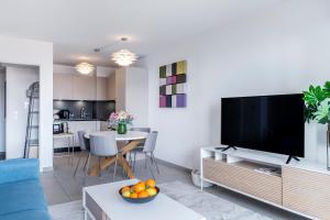 a living room with a large flat screen tv at Victoria Palace- l'appartement avec vue mer et à proximité de Monaco in Beausoleil