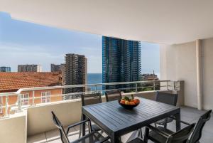 a table on a balcony with a view of the ocean at Victoria Palace- l'appartement avec vue mer et à proximité de Monaco in Beausoleil