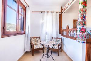 a small table and chairs in a room with a window at Sofia Mike Houses in Olympos