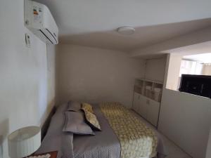 a small bedroom with a bed and a window at Complejo EyE in General Roca