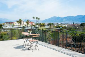 a balcony with a table and chairs and mountains at Residenze Vesuviane - Pompei in Terzigno