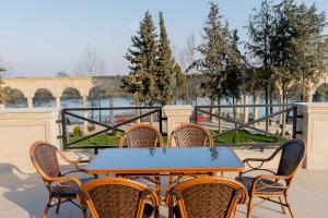 a table and chairs with a view of a bridge at Yevlakh City Hotel in Yevlax