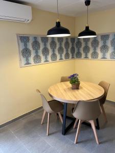 a dining room with a wooden table and chairs at Close to the beach duplex in Tossa de Mar