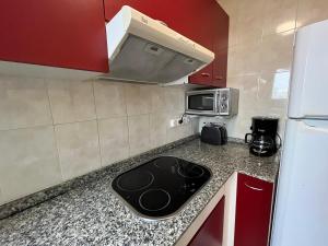 a kitchen with a sink and a microwave at Close to the beach duplex in Tossa de Mar +11 photos