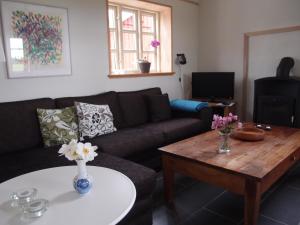a living room with a couch and a coffee table at Bjældskovgaard Holiday House in Funder Kirkeby