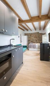a kitchen with stainless steel appliances and a bedroom at El Sueño, Pilaro in Barres