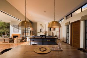 a dining room and living room with a wooden table at Rubi Ranch Lakehouses in Naivasha