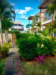 a walkway in front of a building with palm trees at The Aviators Villa in Flic-en-Flac